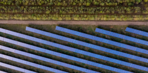 This image: a birds eye photo of a solar farm, showing
							 		 parallel rows of solar panels.
		 							 The map: The map has zoomed out to show the entire Island,
									 with an illustration of the Island's existing energy network,
									 which is detailed in the map key below. The only renewable
									 energy sources shown on the map are the existing Sulby
									 Hydroelectric Plant and the proposed Billown solar farm.